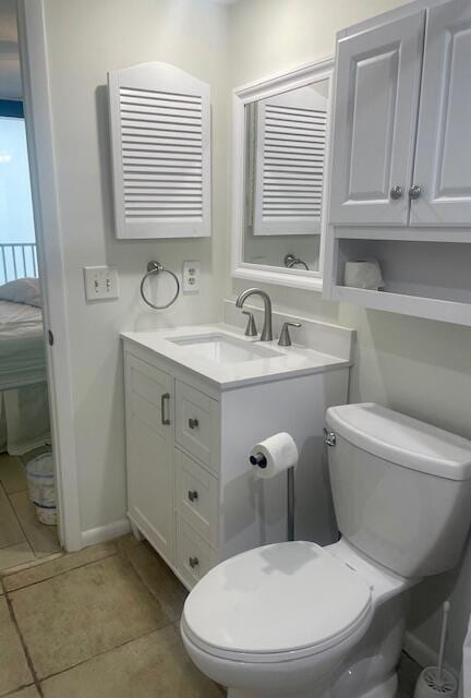 bathroom with tile patterned flooring, vanity, and toilet