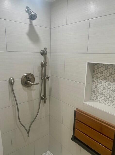 bathroom with tiled shower