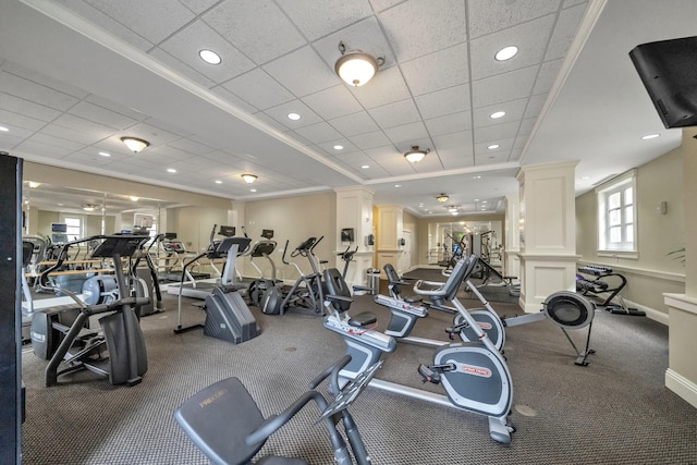 exercise room with crown molding and ornate columns