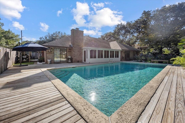 view of pool featuring a wooden deck and a patio