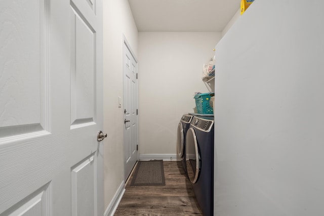 clothes washing area with dark wood-type flooring and independent washer and dryer