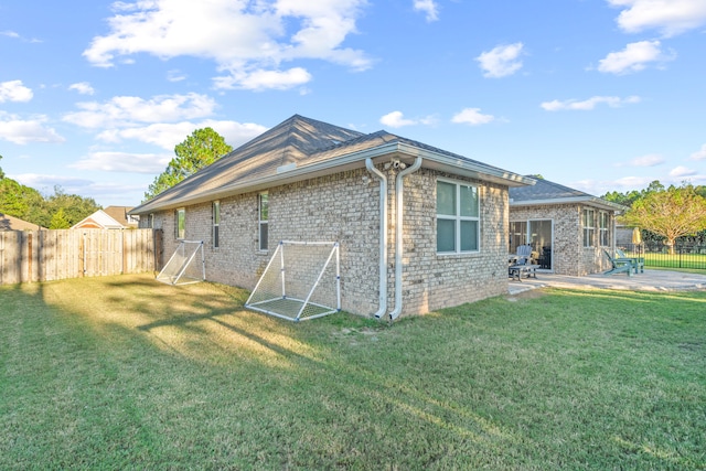 back of property with a patio and a lawn