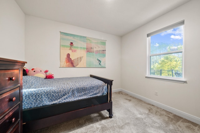 bedroom featuring light carpet