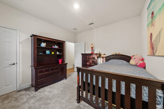 bedroom featuring light colored carpet