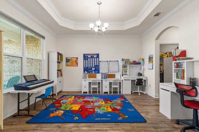 rec room featuring dark wood-type flooring, a raised ceiling, crown molding, and a notable chandelier