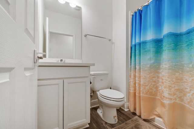 bathroom featuring a shower with curtain, hardwood / wood-style flooring, vanity, and toilet