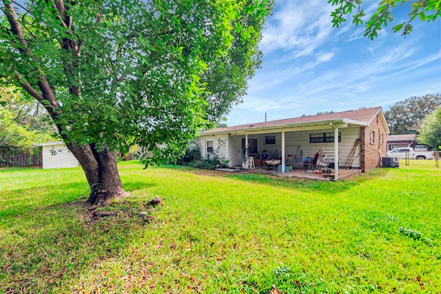 view of yard with central AC and a patio area