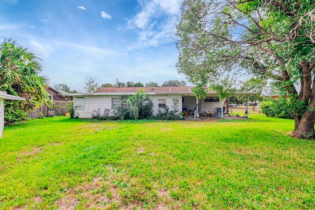 back of property with a lawn