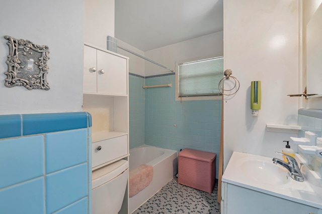 full bathroom with vanity, tiled shower / bath combo, and toilet