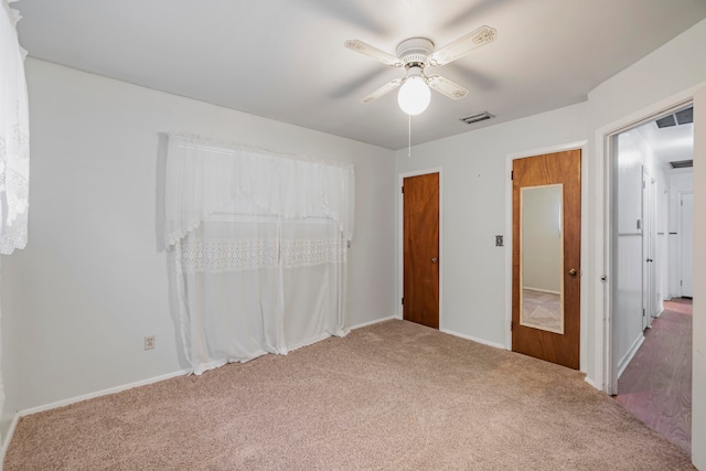 unfurnished bedroom with carpet flooring and ceiling fan