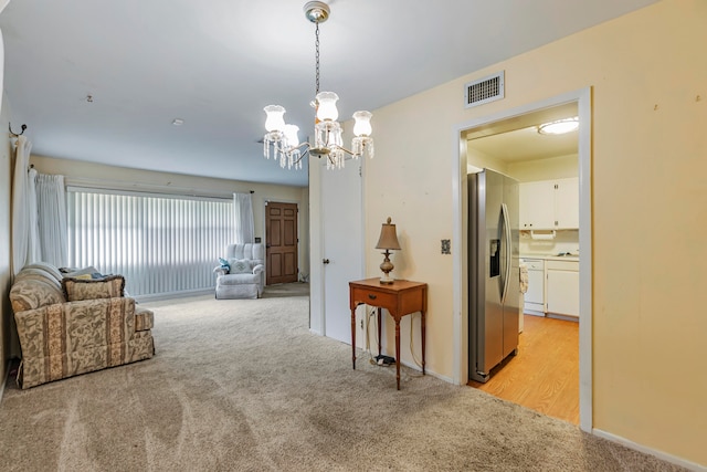 interior space with a chandelier and light carpet