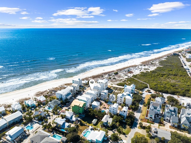 drone / aerial view featuring a water view and a beach view