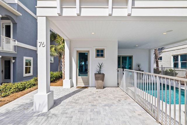 view of patio / terrace with a balcony and a fenced in pool