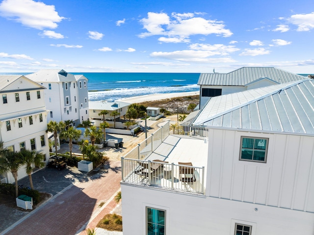 aerial view with a water view and a beach view