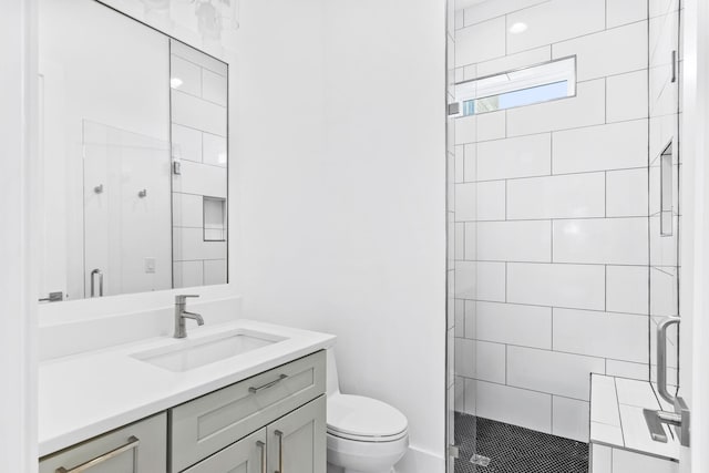 bathroom featuring walk in shower, vanity, and toilet