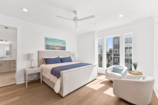 bedroom with ceiling fan, light hardwood / wood-style flooring, connected bathroom, and ornamental molding