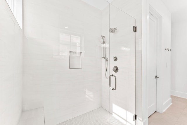 bathroom with walk in shower and tile patterned floors