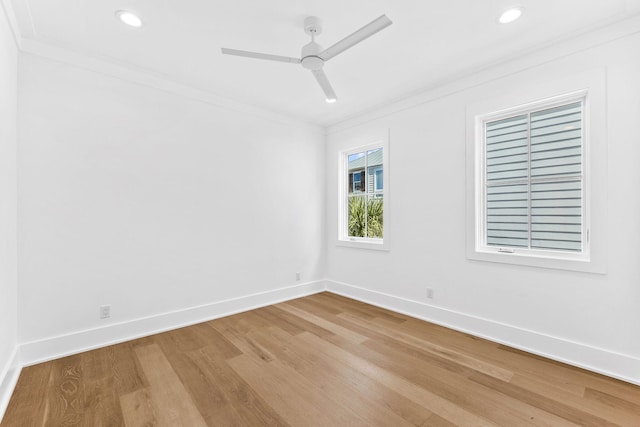 spare room with ceiling fan, hardwood / wood-style floors, and crown molding