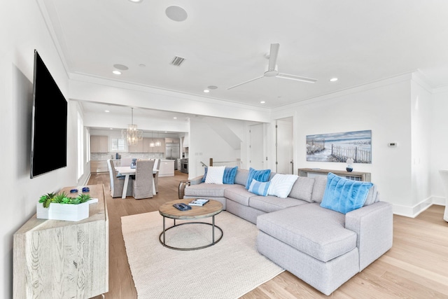 living room with ceiling fan, ornamental molding, and light hardwood / wood-style floors