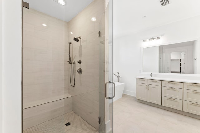 bathroom featuring shower with separate bathtub and vanity