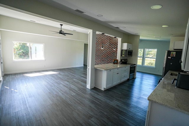 kitchen with light stone countertops, ceiling fan, stainless steel appliances, dark wood-type flooring, and white cabinetry