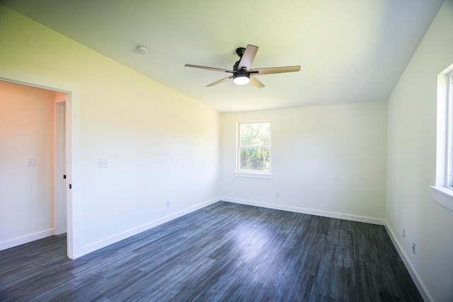 empty room with ceiling fan, lofted ceiling, and dark wood-type flooring