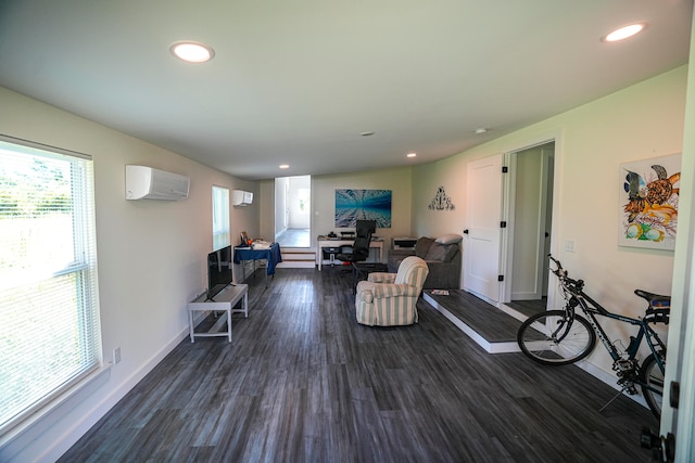 living room featuring dark wood-type flooring and an AC wall unit