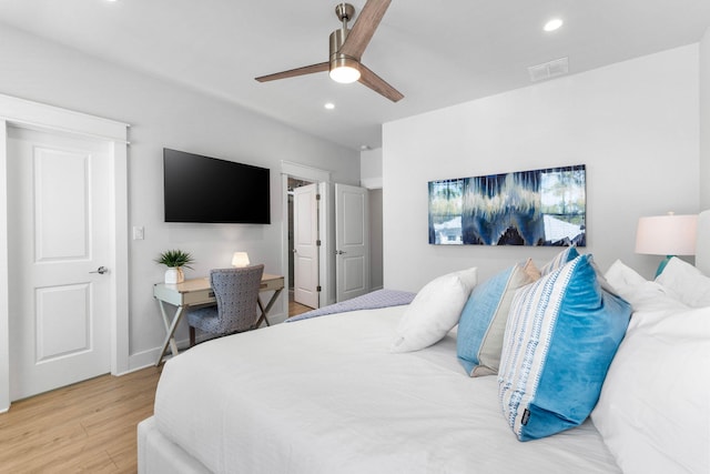 bedroom with light hardwood / wood-style flooring and ceiling fan