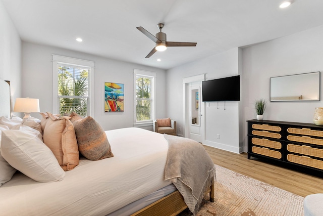 bedroom with ceiling fan and hardwood / wood-style flooring