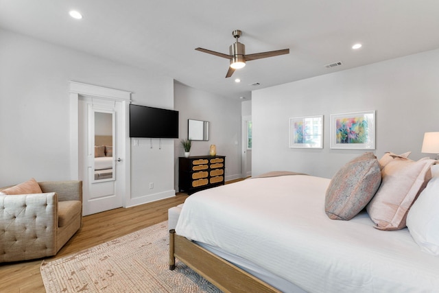 bedroom with ceiling fan and light hardwood / wood-style floors