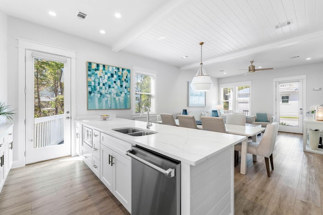 kitchen with beamed ceiling, sink, white cabinets, light hardwood / wood-style flooring, and stainless steel dishwasher