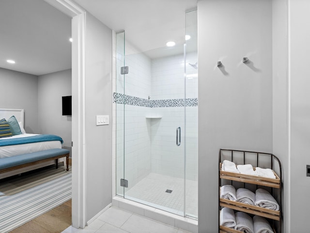 bathroom featuring tile patterned floors and a shower with shower door