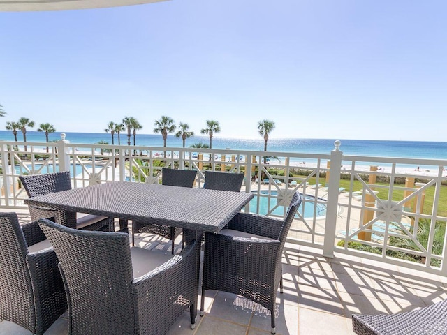 view of patio with a water view and a view of the beach