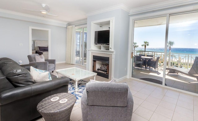 living room featuring ceiling fan, light tile patterned flooring, and ornamental molding