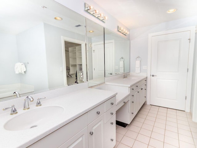 bathroom with tile patterned flooring and vanity