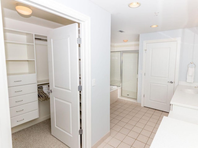 bathroom featuring vanity, tile patterned flooring, and a shower with shower door