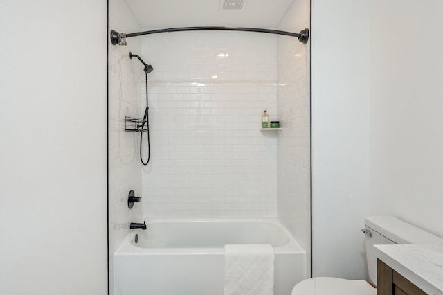 full bathroom with vanity, tiled shower / bath, and toilet