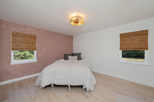 bedroom featuring light hardwood / wood-style floors and multiple windows