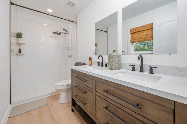 bathroom with vanity, toilet, hardwood / wood-style flooring, and a shower with curtain