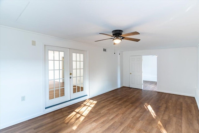 empty room with crown molding, ceiling fan, dark wood-type flooring, and french doors