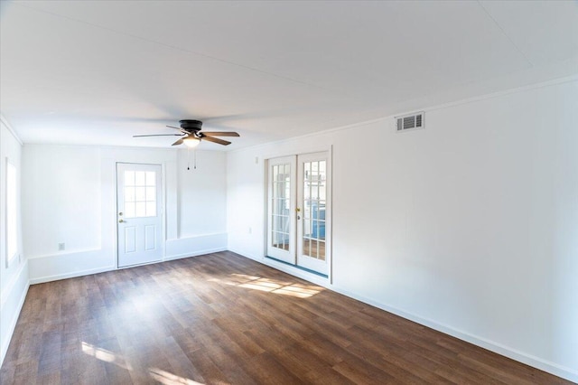 spare room with french doors, dark hardwood / wood-style floors, ornamental molding, and ceiling fan