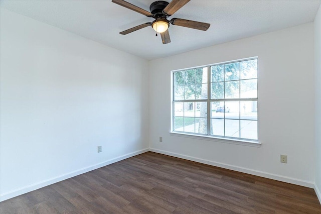 unfurnished room featuring dark hardwood / wood-style flooring and ceiling fan