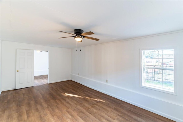 empty room featuring dark hardwood / wood-style flooring and ceiling fan