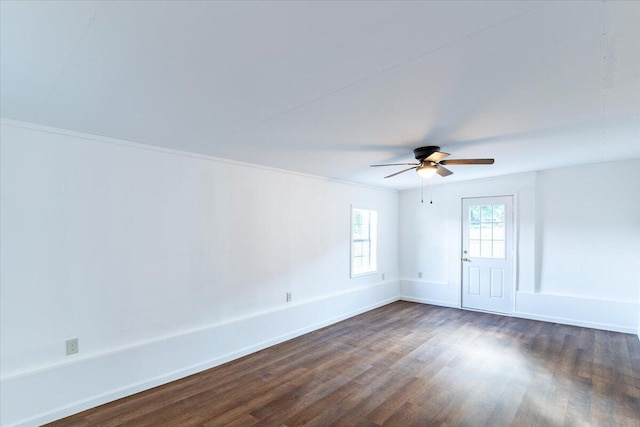 empty room featuring ceiling fan, dark hardwood / wood-style floors, and ornamental molding