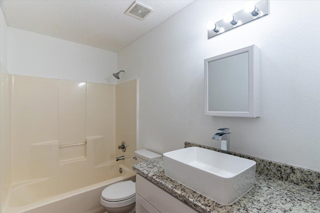 full bathroom with vanity, a textured ceiling, bathtub / shower combination, and toilet