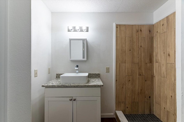 bathroom with vanity and a textured ceiling