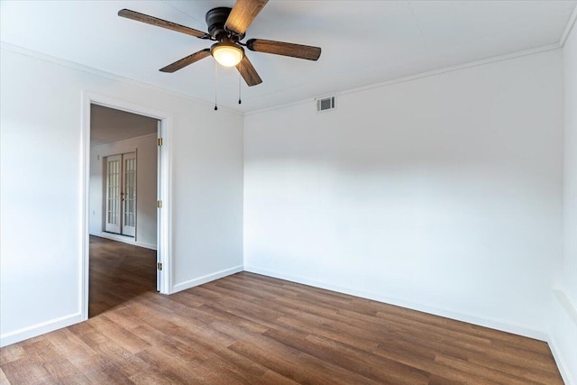 empty room with ceiling fan, hardwood / wood-style flooring, and crown molding