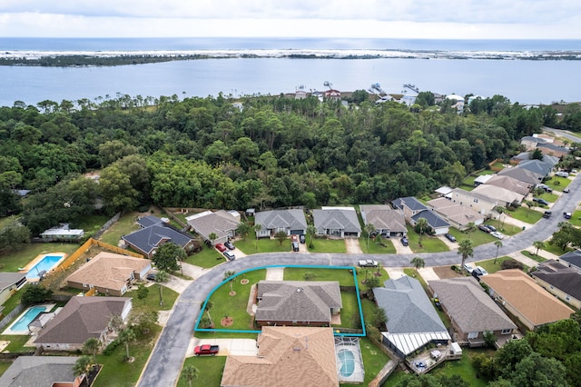 birds eye view of property with a water view