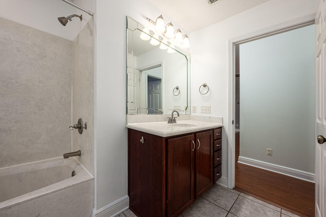 bathroom featuring wood-type flooring, vanity, and  shower combination