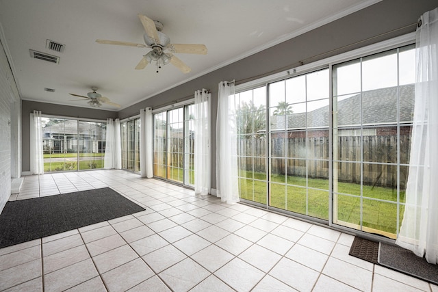 unfurnished sunroom featuring ceiling fan